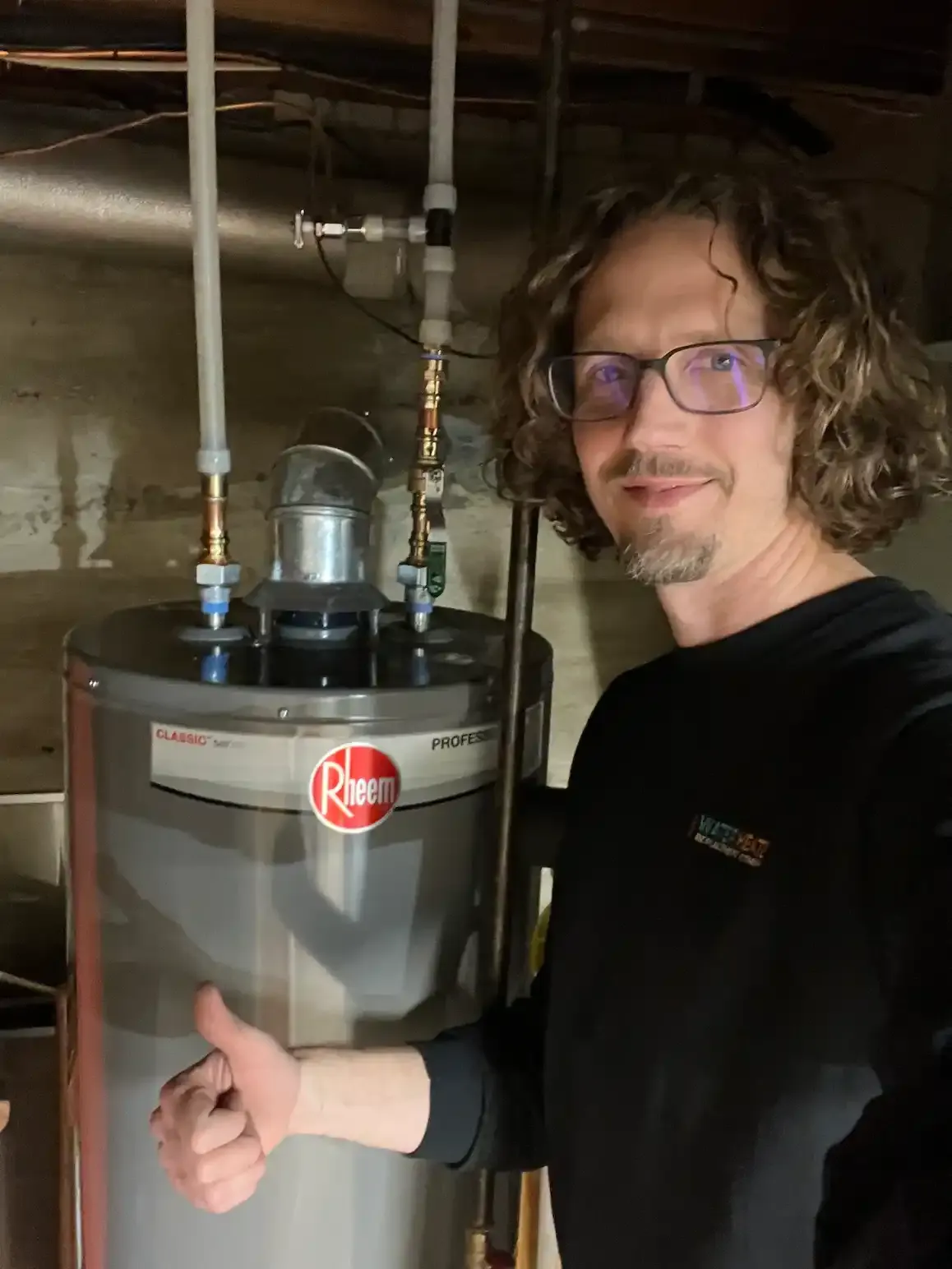 Water Heater Replacement Company technician standing next to service van in West Michigan